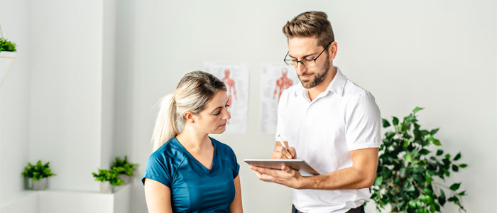 chiropractor consulting a patient